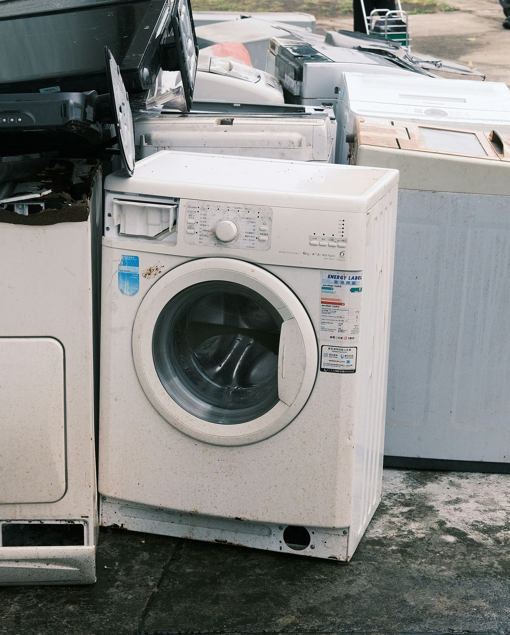 a pile of washing machines sitting next to each other